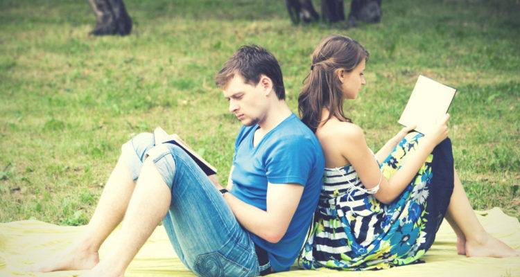 couple reading in a park in the summer