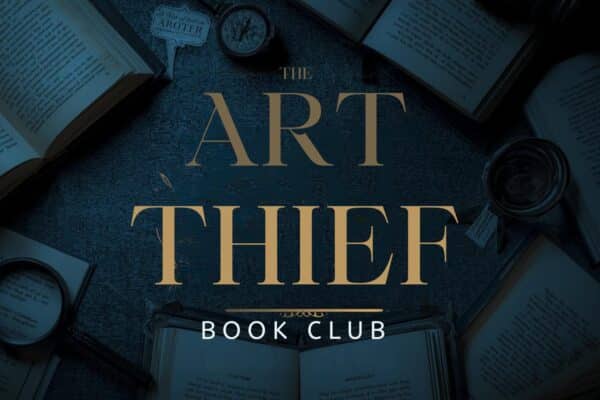 A table of open books in a dark background behind the words "The Art Thief" book club.