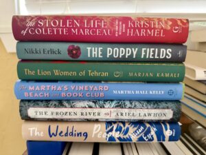 Stack of book club recommendations--hard cover titles.